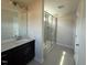 Bathroom showcasing vanity sink and a glass-enclosed shower stall at 118 Fairwinds Drive Dr, Lillington, NC 27546