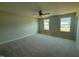 Spacious bedroom with neutral carpet, ceiling fan, and natural light from windows at 118 Fairwinds Drive Dr, Lillington, NC 27546
