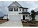 Charming two-story home features a two-car garage and a well-maintained lawn at 118 Fairwinds Drive Dr, Lillington, NC 27546