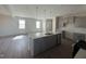 Open-concept kitchen with an island, stainless steel appliances, and an adjacent living area at 118 Fairwinds Drive Dr, Lillington, NC 27546