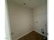 Bright laundry area with overhead shelving and hookups for washer and dryer at 118 Fairwinds Drive Dr, Lillington, NC 27546