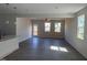 Open-concept living room with hardwood floors, plenty of light, and neutral paint at 118 Fairwinds Drive Dr, Lillington, NC 27546