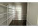 Spacious walk-in pantry featuring white metal shelving for ample storage at 118 Fairwinds Drive Dr, Lillington, NC 27546