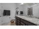 Bright bathroom featuring double sinks, granite countertops, and neutral tile flooring for a clean, modern aesthetic at 1207 Bluewater Way, Durham, NC 27703