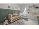 Charming Bedroom with a crib, glider, and nature-themed decor, creating a cozy and inviting space at 1207 Bluewater Way, Durham, NC 27703