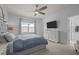 Serene bedroom features a ceiling fan, neutral decor, and a large window for natural light at 1207 Bluewater Way, Durham, NC 27703