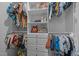 Organized walk-in closet with shelves, drawers, and rods for hanging clothes, maximizing storage space at 1207 Bluewater Way, Durham, NC 27703