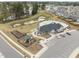 Aerial view of community pool, playground, and dog park amenities with parking and surrounding residences at 1207 Bluewater Way, Durham, NC 27703
