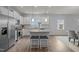 Bright open kitchen with island seating, stainless steel appliances, and views of the dining area at 1207 Bluewater Way, Durham, NC 27703