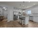Bright kitchen featuring a center island with seating, stainless steel appliances, and an open layout at 1207 Bluewater Way, Durham, NC 27703