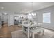 Charming eat-in kitchen showcases a breakfast bar, white cabinets, stainless appliances, and modern pendant lights at 1207 Bluewater Way, Durham, NC 27703