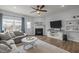 This comfortable living room features a fireplace, large TV, and a view to the backyard at 1207 Bluewater Way, Durham, NC 27703
