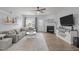 Cozy living room features a ceiling fan, fireplace, built-in shelves and plenty of natural light at 1207 Bluewater Way, Durham, NC 27703