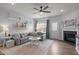 Inviting living room features a fireplace, soft gray furniture, and a light-filled window at 1207 Bluewater Way, Durham, NC 27703