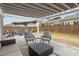 Open patio design with lounge seating, outdoor rug, grill, and backyard views at 1207 Bluewater Way, Durham, NC 27703