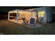 Inviting outdoor patio featuring string lights, comfortable seating, grill and gray adirondack chairs at 1207 Bluewater Way, Durham, NC 27703