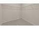 A carpeted walk-in closet featuring white walls, baseboards, and wire shelving for ample storage space at 1207 Bluewater Way, Durham, NC 27703