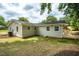 Rear exterior of house with manicured grass and wooden deck seating area at 122 W Union St, Hillsborough, NC 27278