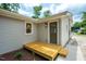 Backyard exterior featuring a wooden deck area and brown painted door at 122 W Union St, Hillsborough, NC 27278