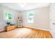Bright bedroom featuring wood floors, white trim, natural light, and a wooden chest at 122 W Union St, Hillsborough, NC 27278