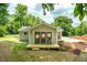 Quaint home with a back deck featuring a table and chairs, neutral siding, and mature trees at 122 W Union St, Hillsborough, NC 27278