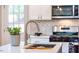 Kitchen with stainless steel appliances, sleek countertops, and a garden window at 122 W Union St, Hillsborough, NC 27278