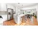 Open concept kitchen with island, stainless steel appliances, and hardwood floors at 122 W Union St, Hillsborough, NC 27278