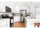 Contemporary kitchen featuring stainless steel appliances and sleek white countertops at 122 W Union St, Hillsborough, NC 27278