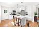 Modern kitchen with white cabinetry, stainless steel appliances, and a center island at 122 W Union St, Hillsborough, NC 27278