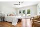 Sun-filled main bedroom features french doors and wood floors at 122 W Union St, Hillsborough, NC 27278
