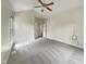 Bedroom features neutral carpet, ceiling fan, and doorway to en suite at 12316 Amoretto Way, Raleigh, NC 27613