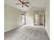 Bedroom features neutral carpet, ceiling fan, and view from bright window at 12316 Amoretto Way, Raleigh, NC 27613