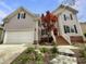 Charming two-story home featuring a red front door and an attached garage, with beautifully landscaped front yard at 12316 Amoretto Way, Raleigh, NC 27613