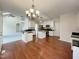 Bright, open kitchen and dining area with an island, modern lighting, and hardwood floors at 12316 Amoretto Way, Raleigh, NC 27613