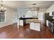 Bright, open kitchen with white cabinets, island, and modern appliances perfect for cooking and entertaining at 12316 Amoretto Way, Raleigh, NC 27613
