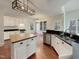 Open kitchen with white cabinets, butcher block island, and stainless steel appliances offers style and functionality at 12316 Amoretto Way, Raleigh, NC 27613