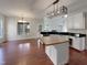 Spacious kitchen with white cabinetry, butcher block island, and eat-in area with large windows at 12316 Amoretto Way, Raleigh, NC 27613