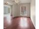 Living room features hardwood floors, large windows, and lots of sunlight at 12316 Amoretto Way, Raleigh, NC 27613