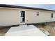Newly installed concrete patio and exterior featuring beige siding at 129 Grace Pond Ave, Benson, NC 27504