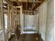 Bathroom with fiberglass insulation showing shower with built in seating at 129 Grace Pond Ave, Benson, NC 27504