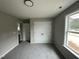 A carpeted bedroom with natural light, closet, and neutral paint at 129 Grace Pond Ave, Benson, NC 27504