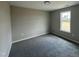 Simple bedroom with neutral colors, a window, and carpeted floors at 129 Grace Pond Ave, Benson, NC 27504