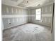 Spacious bedroom featuring a large window and modern ceiling design during the construction phase at 129 Grace Pond Ave, Benson, NC 27504