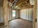 Newly framed bedroom with fiberglass insulation and a window for natural light at 129 Grace Pond Ave, Benson, NC 27504