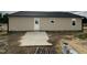Tan home exterior with a concrete patio, door and windows that provide natural light at 129 Grace Pond Ave, Benson, NC 27504