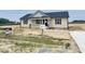 Charming single-story home featuring a covered porch and newly installed siding, walkway, and mailbox at 129 Grace Pond Ave, Benson, NC 27504