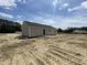 The home features neutral colored siding, a gray roof, and a concrete patio in the backyard at 129 Grace Pond Ave, Benson, NC 27504