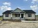 Charming single-story home with a covered front porch and stone accents at 129 Grace Pond Ave, Benson, NC 27504