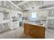 Bright kitchen area with high ceilings, white cabinets, and modern fixtures, under construction at 129 Grace Pond Ave, Benson, NC 27504