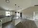 Well-lit kitchen with an island, granite countertops, and stainless steel appliances at 129 Grace Pond Ave, Benson, NC 27504